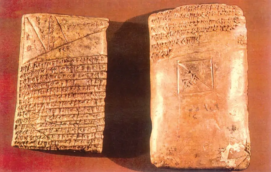 A clay tablet written on both sides in cuneiform. It is a mathematical exercise – you can see a triangle and lines across the triangle on the top of the obverse side